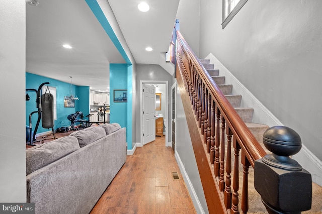 stairs featuring recessed lighting, visible vents, baseboards, and hardwood / wood-style flooring