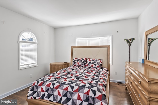 bedroom with dark wood-style floors and baseboards