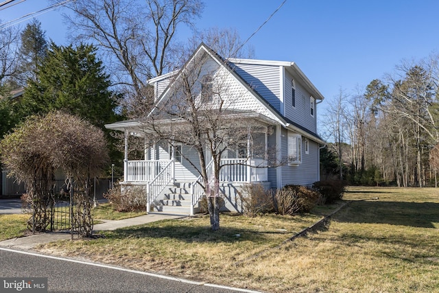 view of front of home with covered porch and a front yard