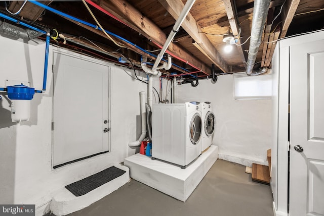 clothes washing area featuring laundry area and washer and clothes dryer