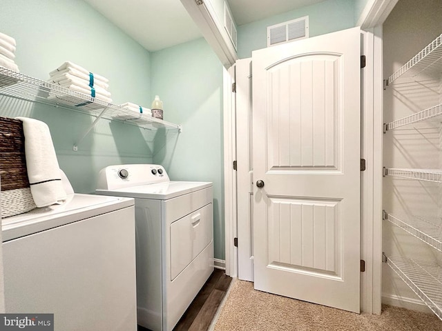 clothes washing area featuring independent washer and dryer, laundry area, and visible vents