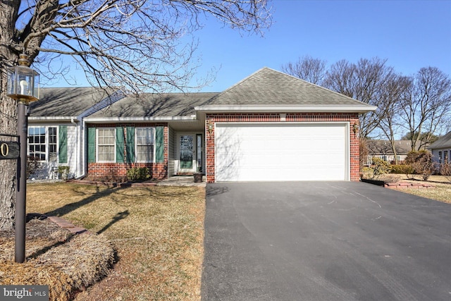 single story home with aphalt driveway, a garage, brick siding, and a shingled roof