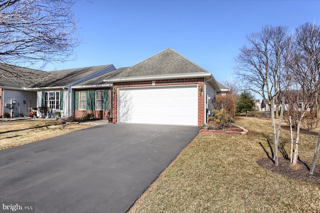 view of front of house with aphalt driveway, brick siding, an attached garage, and a shingled roof