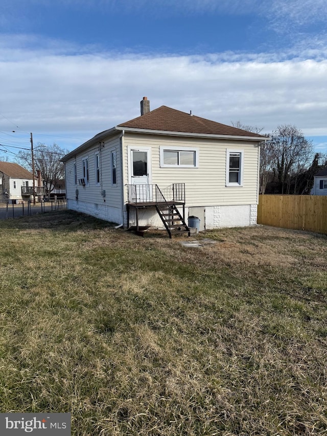 239 Midland, Brooklyn, MD 21225 - rear view of property with a lawn, a chimney, fence, and crawl space