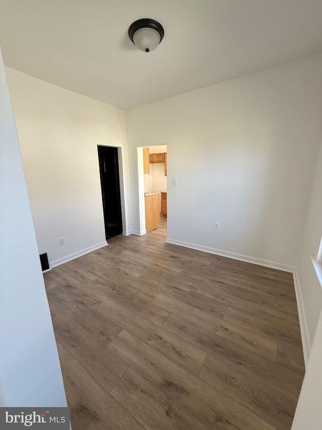 239 Midland, Brooklyn, MD 21225 - spare room with baseboards and wood finished floors