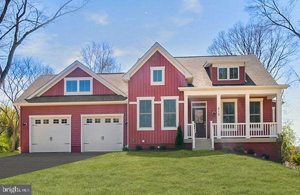 view of front facade featuring board and batten siding, a porch, a front lawn, and aphalt driveway