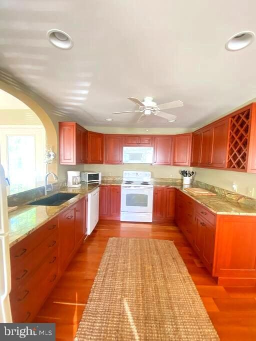 kitchen featuring a sink, white appliances, light wood-style flooring, and recessed lighting