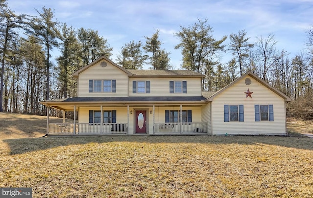 view of front of home with covered porch and a front yard