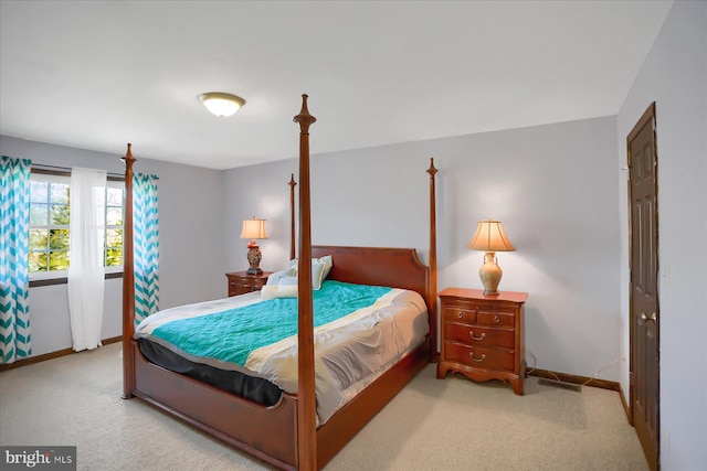 carpeted bedroom featuring baseboards