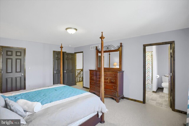 bedroom with visible vents, baseboards, and light carpet