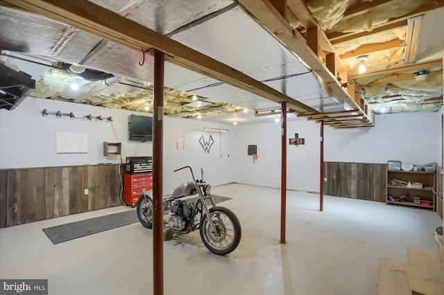 unfinished below grade area with wood walls and wainscoting