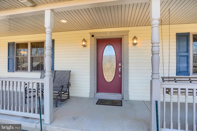 view of exterior entry with a porch