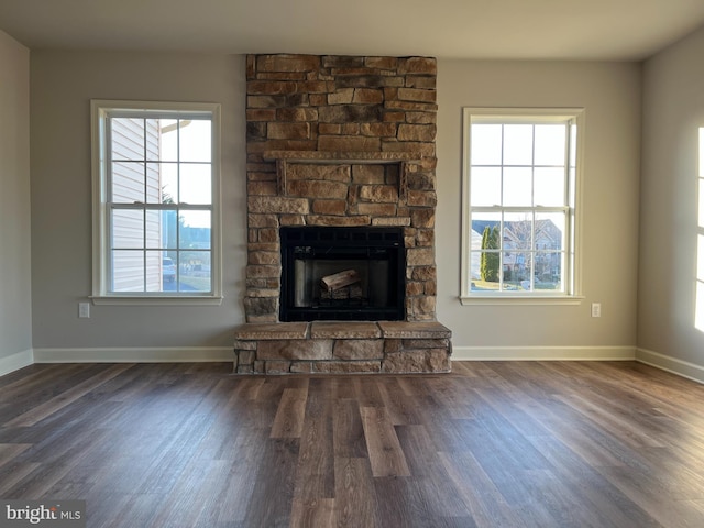 unfurnished living room with wood finished floors and a wealth of natural light