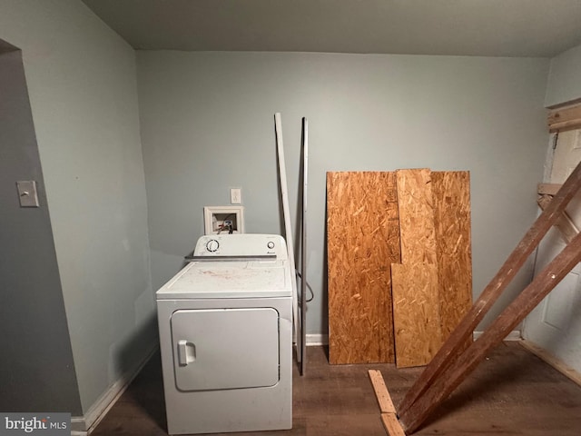 clothes washing area with laundry area, washer / clothes dryer, baseboards, and wood finished floors