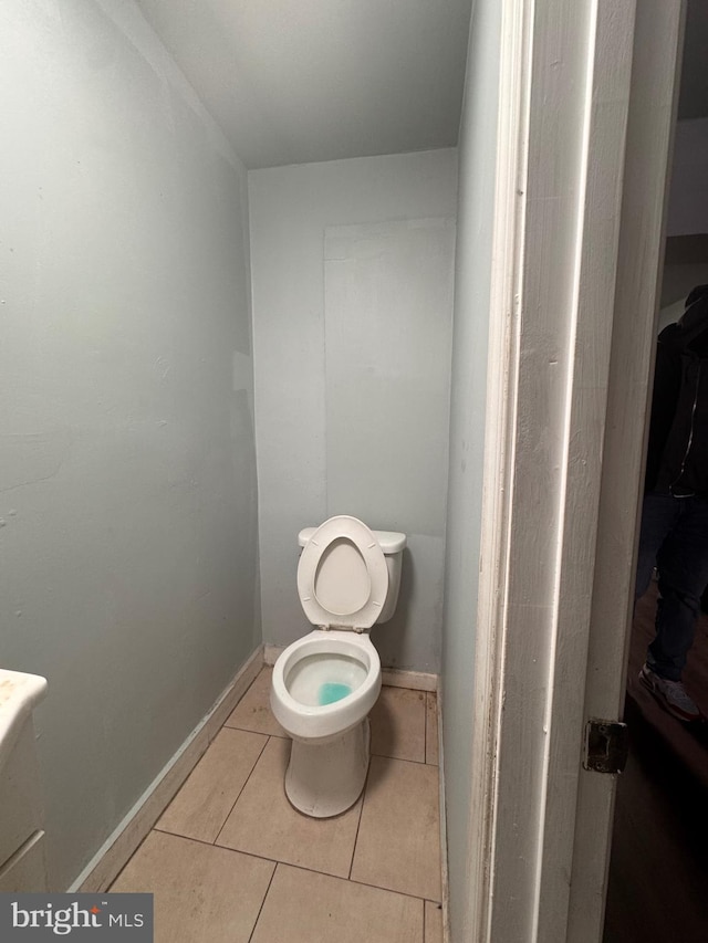 bathroom featuring tile patterned floors, toilet, and baseboards