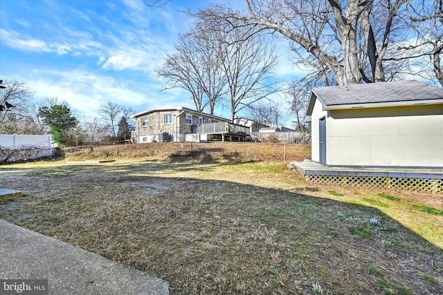 view of yard with an outdoor structure and fence