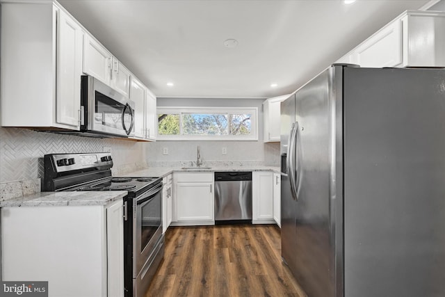 kitchen with white cabinets, stainless steel appliances, dark wood-type flooring, and a sink