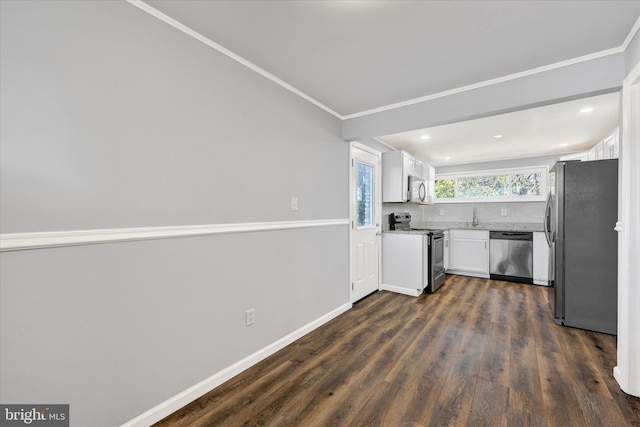 kitchen featuring dark wood-type flooring, light countertops, appliances with stainless steel finishes, white cabinetry, and backsplash