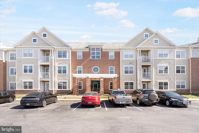 view of building exterior with uncovered parking