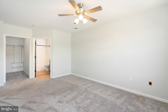 unfurnished bedroom with a ceiling fan, light colored carpet, visible vents, and baseboards