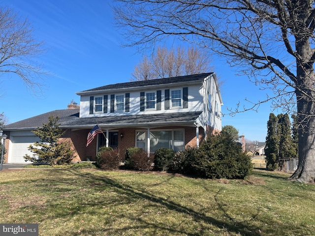 traditional home featuring a front lawn, brick siding, a chimney, and an attached garage