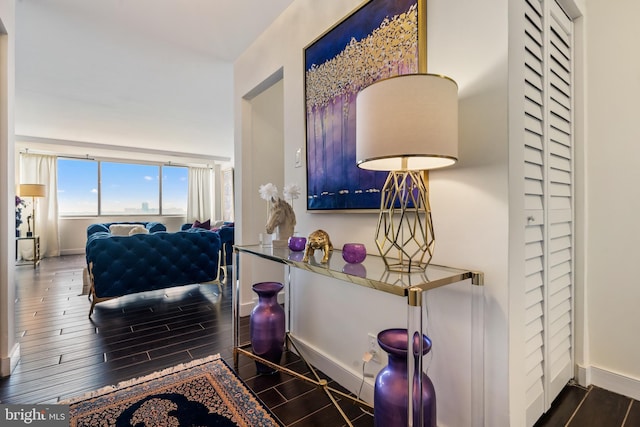 interior space with baseboards and wood tiled floor