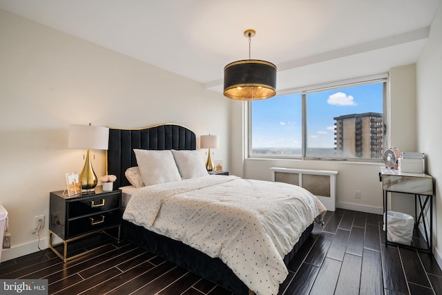 bedroom featuring baseboards and wood finish floors