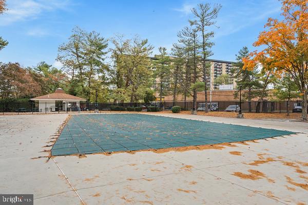 community pool featuring a patio and fence