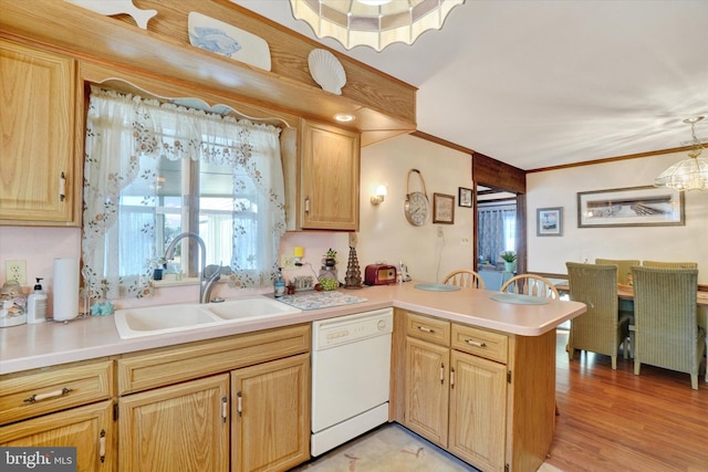 kitchen featuring ornamental molding, a sink, a peninsula, light countertops, and dishwasher