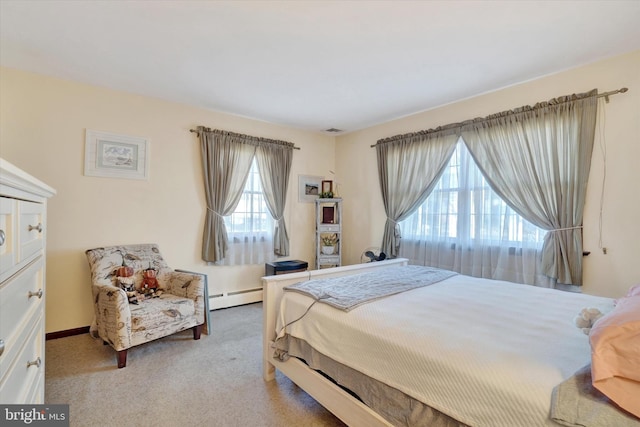 bedroom featuring a baseboard heating unit, baseboards, visible vents, and light carpet