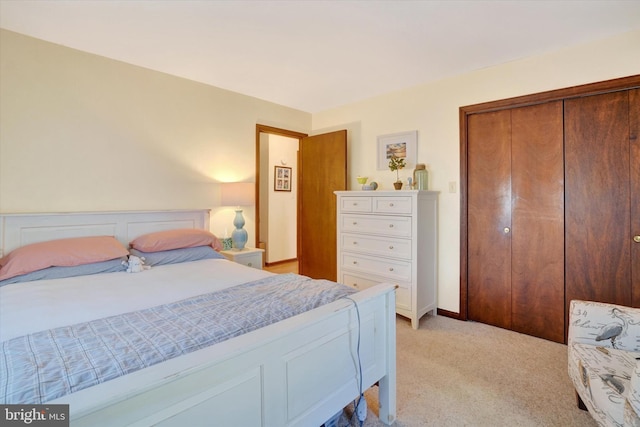 bedroom with a closet and light carpet