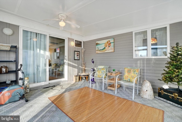 sunroom / solarium featuring ceiling fan