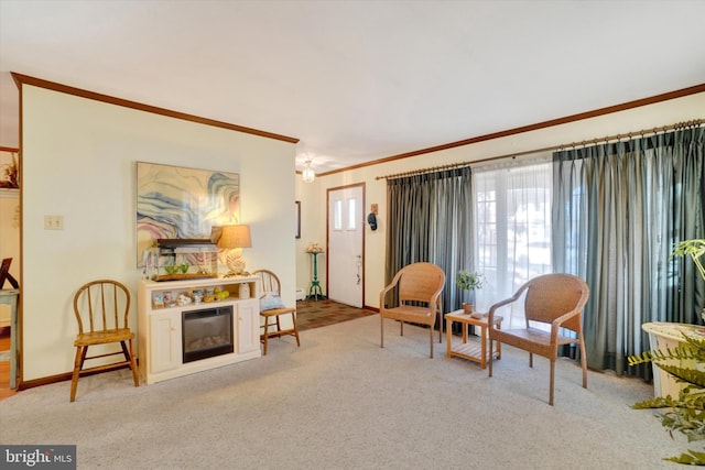 living area with carpet, a fireplace, baseboards, and ornamental molding