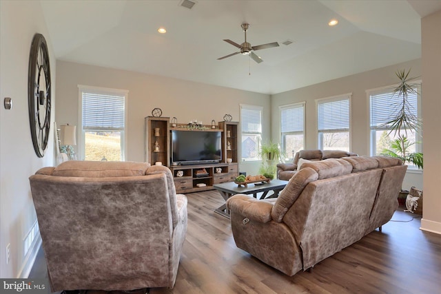 living area with a wealth of natural light, visible vents, recessed lighting, and wood finished floors