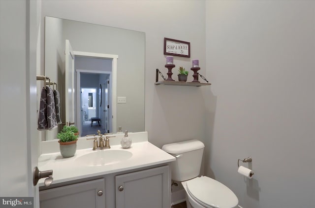 bathroom featuring toilet and vanity