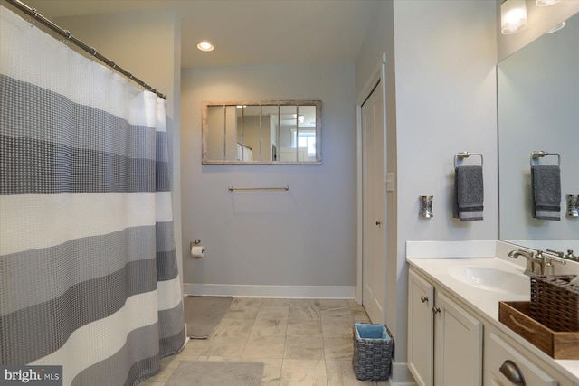 full bathroom with recessed lighting, vanity, and baseboards