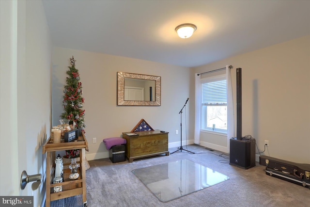 interior space featuring carpet flooring and baseboards