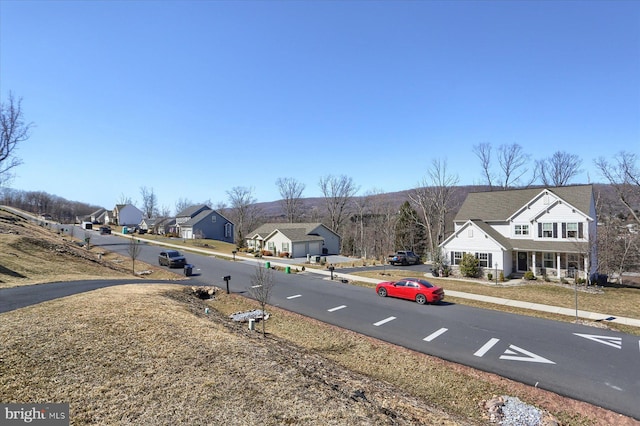 view of road with a residential view and sidewalks