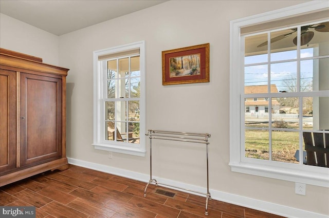 entryway featuring baseboards and wood tiled floor