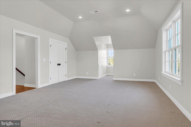 bonus room with vaulted ceiling, carpet flooring, baseboards, and visible vents