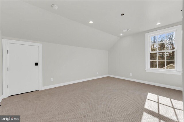 bonus room featuring vaulted ceiling, carpet flooring, and baseboards