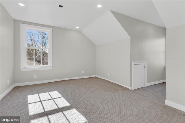 additional living space with recessed lighting, baseboards, lofted ceiling, and carpet floors