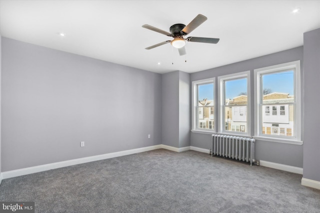 empty room with ceiling fan, radiator, carpet, and baseboards