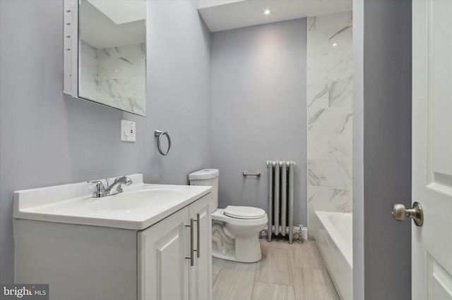 bathroom with radiator, toilet, and vanity