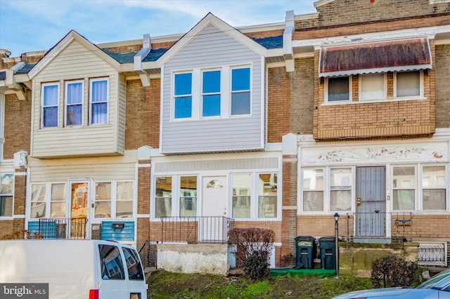 townhome / multi-family property with brick siding