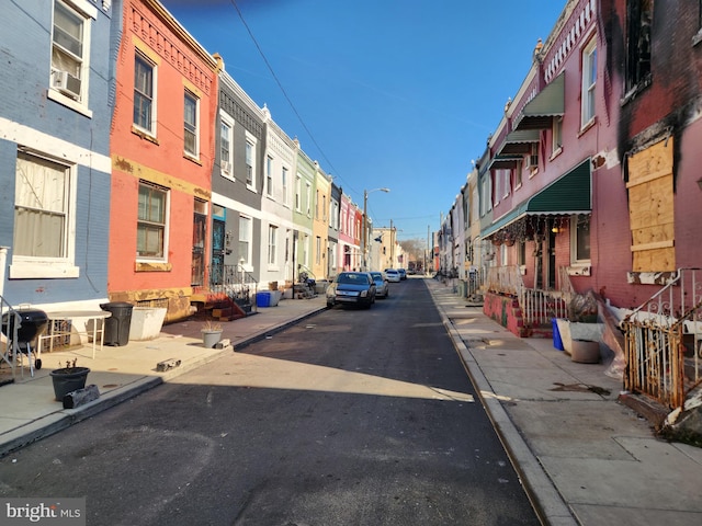 view of street with curbs, sidewalks, and a residential view