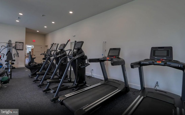 exercise room with recessed lighting and baseboards