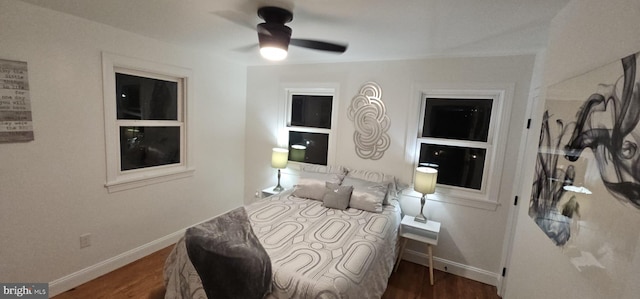 bedroom with a ceiling fan, baseboards, and wood finished floors