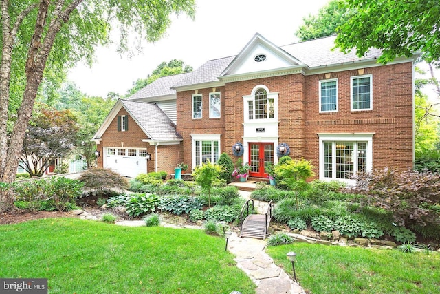 11905 Champion Lake Ct, Herndon, VA 20170 - colonial house featuring brick siding, a front lawn, roof with shingles, and a garage