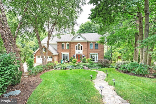 11905 Champion Lake Ct, Herndon, VA 20170 - colonial home featuring a front lawn, brick siding, and french doors